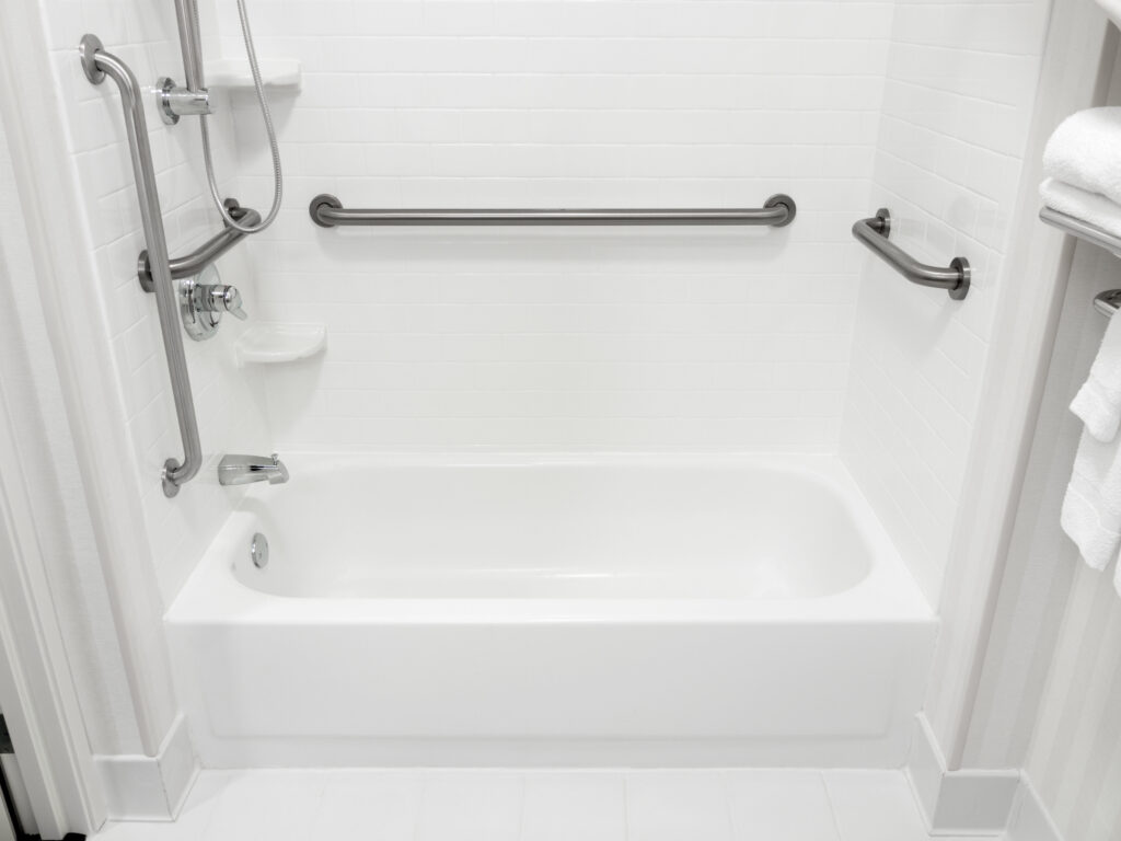 A bathtub with hand rails