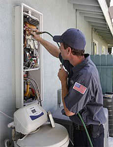 A technician working on a hot water recirculation system