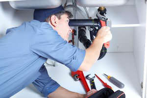 Plumber repairing a sink