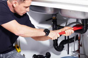 Plumber fixing sink pipes in Stanton