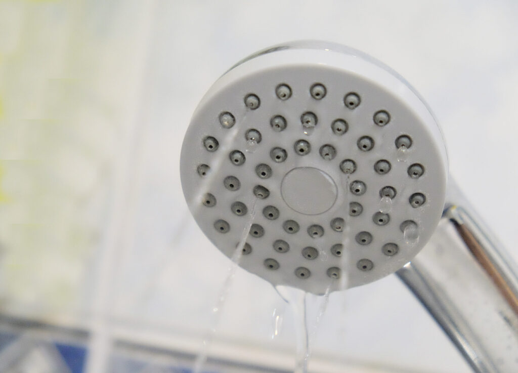 A shower head with water streaming out of it