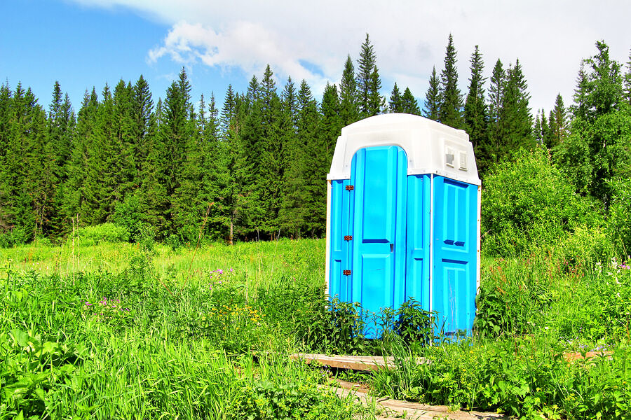 A port-a-potty in a field