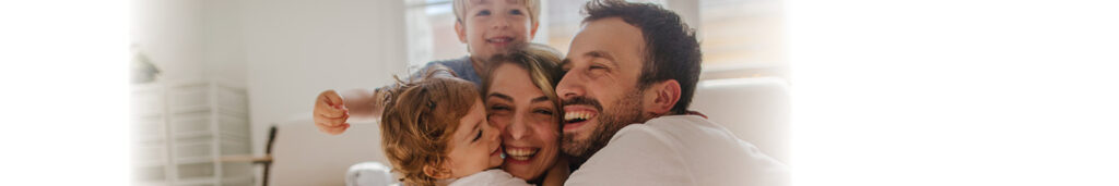 Family hugging in their Orange County home