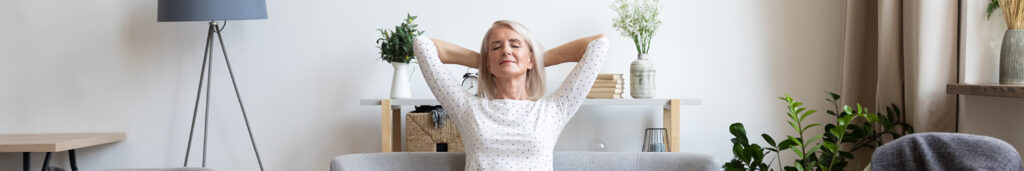 Woman relaxing in her Orange County home after getting her air conditioner tuned up