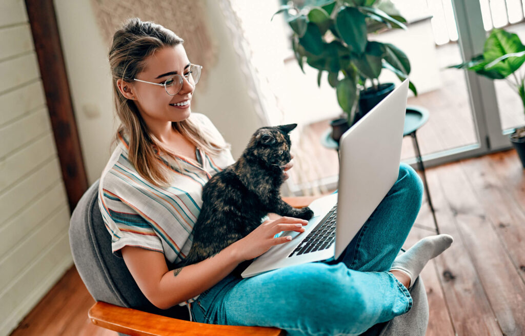 Woman with a cat and laptop